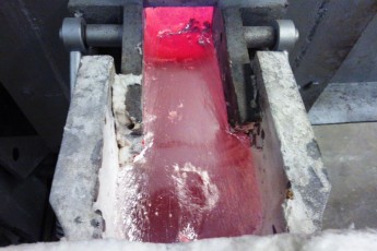 Melting and continuous casting section in an aluminium slug plant