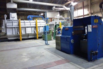Melting and continuous casting section in an aluminium slug plant