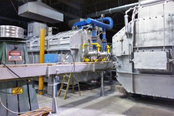 Melting and continuous casting section in an aluminium slug plant